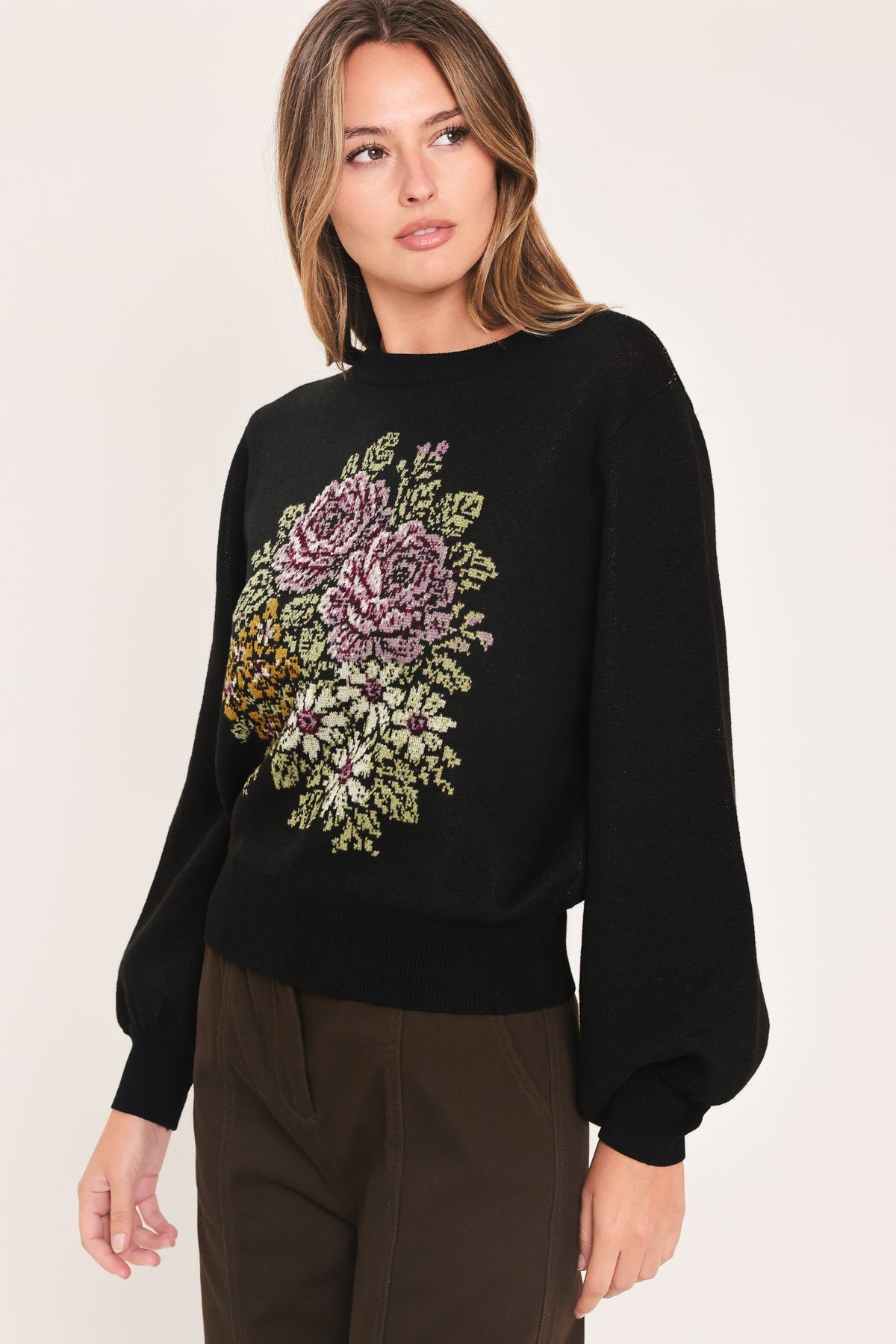 Black crewneck sweater with floral pixel embroidery at center front