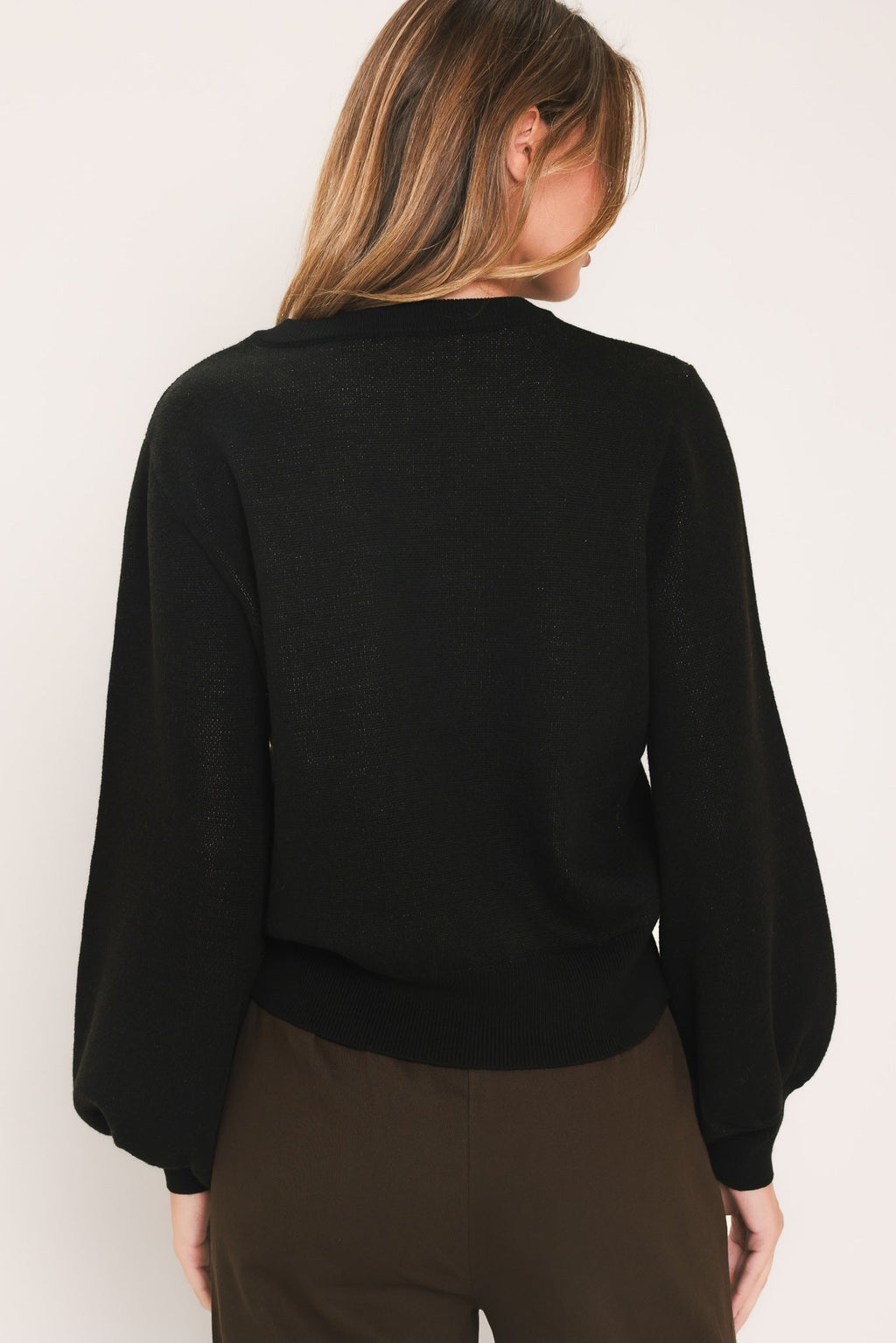 Black balloon-sleeve sweater, back view with crew neck