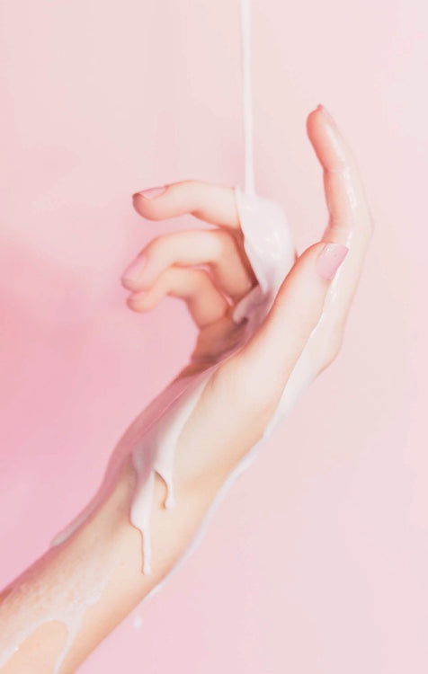 Hand applying clear lotion with gel on fingertips