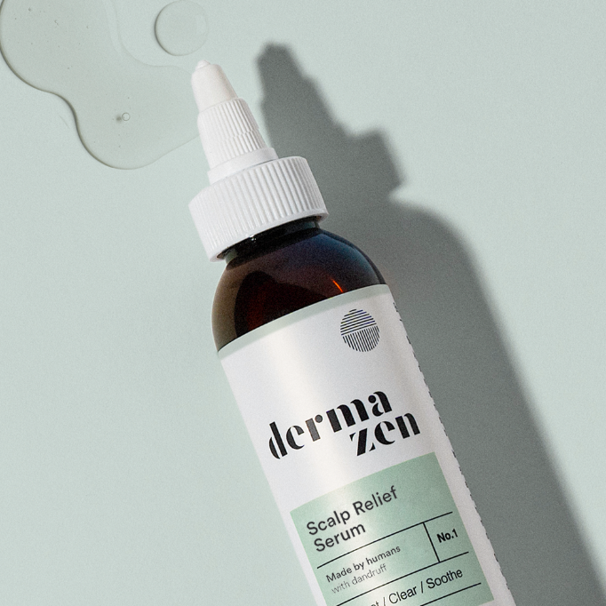 Close-up of amber Calming Seborrheic Serum bottle with white label and dropper top