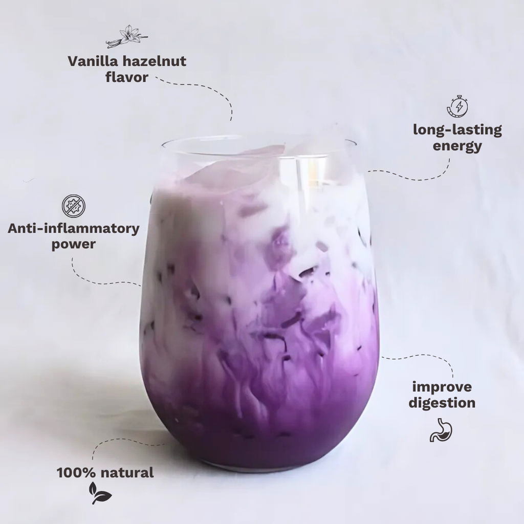 Purple ube drink in a clear glass with a creamy swirl texture