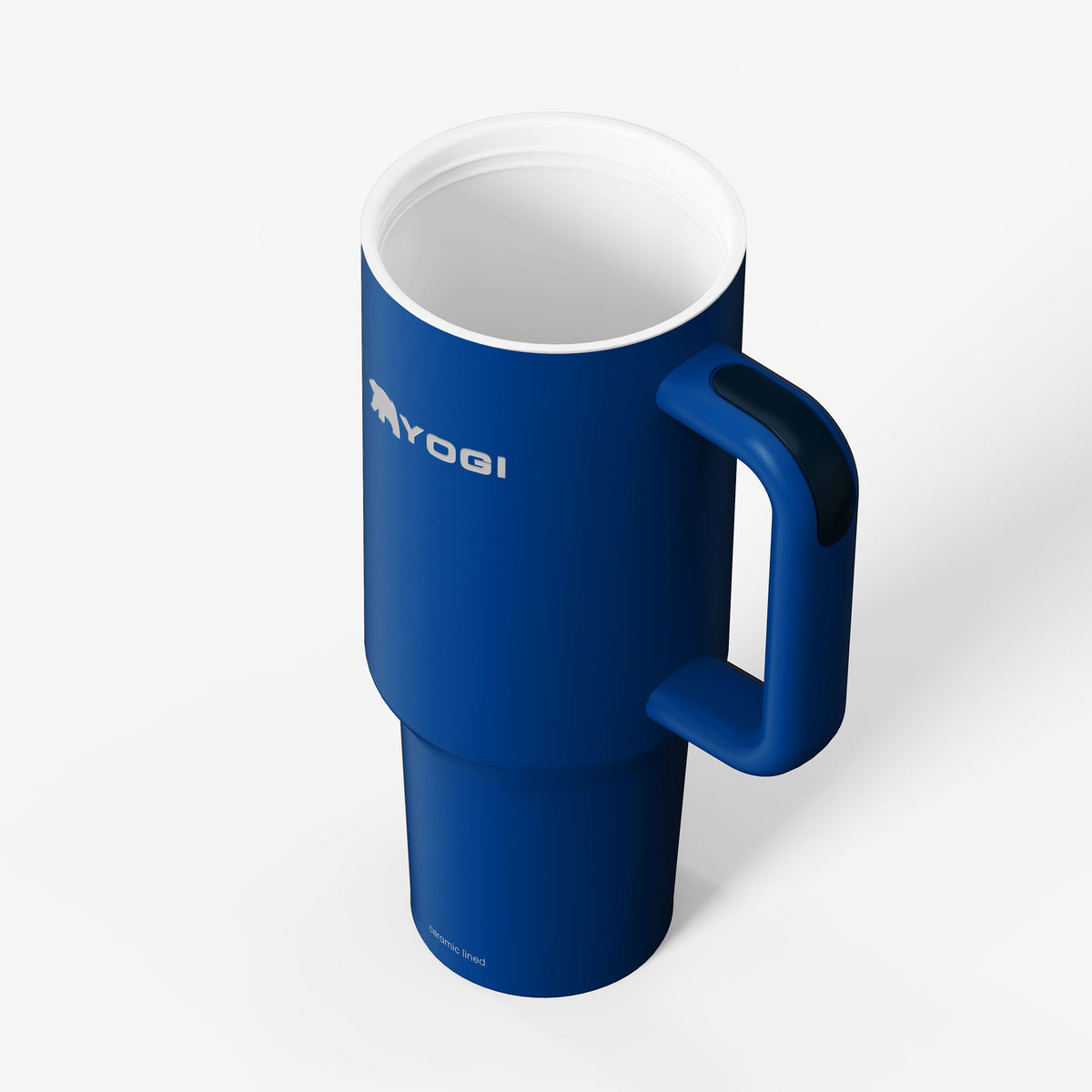 Blue ceramic-lined tumbler with curved handle; top rim and interior visible