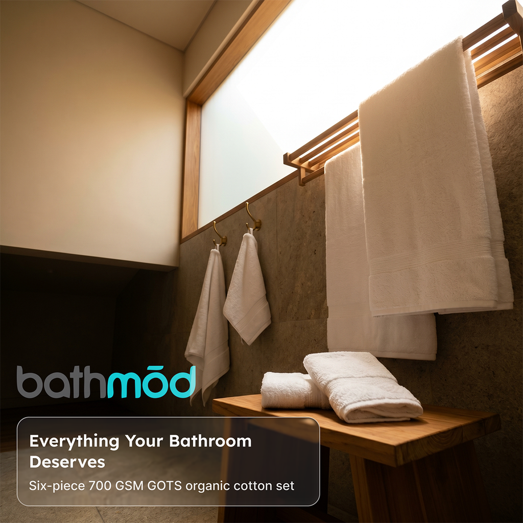 White six-piece towel set hanging on a wooden rack, plush folded towels