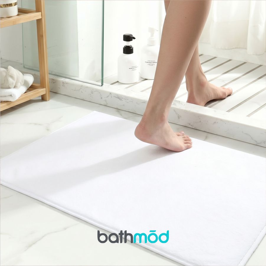 White rectangular bath mat with stitched edges