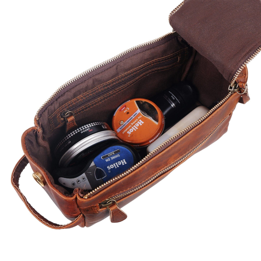 Open brown dopp kit showing interior zip pouch and bottles