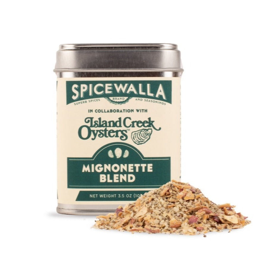 SpiceWalla mignonette blend tin with seasoning mix pile on a white surface