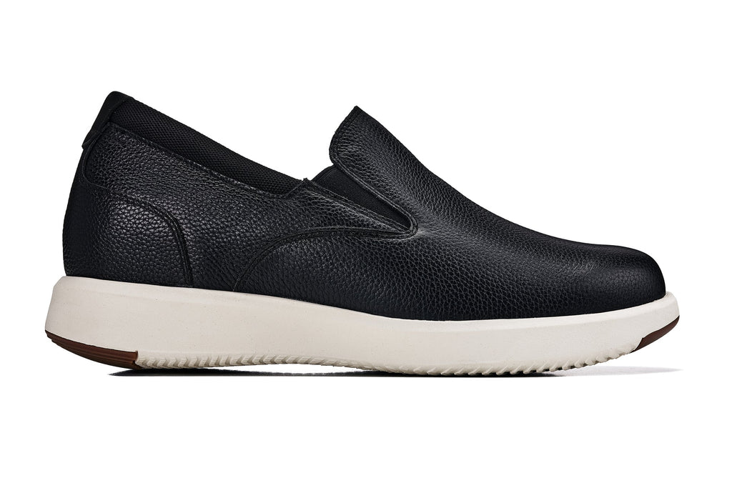 Black leather slip-on loafer with V-shaped opening and white outsole, side profile