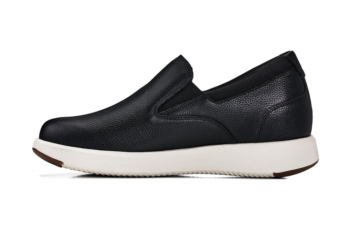 Black leather slip-on loafer with minimal seams and white sole, front 3/4 view