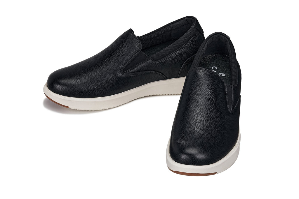 Black leather loafers with white midsoles and low-profile heel, angled side view