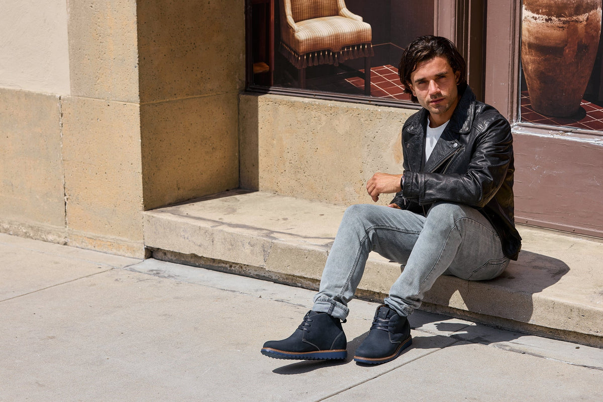 Men's navy nubuck chukka boots with lace-up closure and brown sole trim