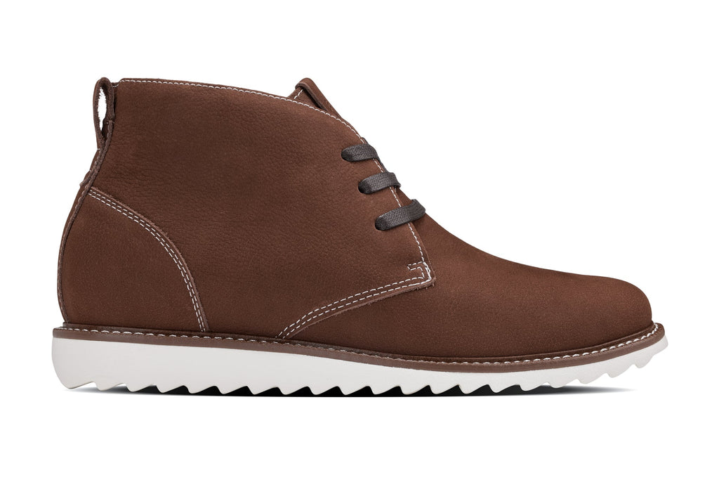 Brown nubuck chukka boots with lace-up eyelets and white rubber outsole
