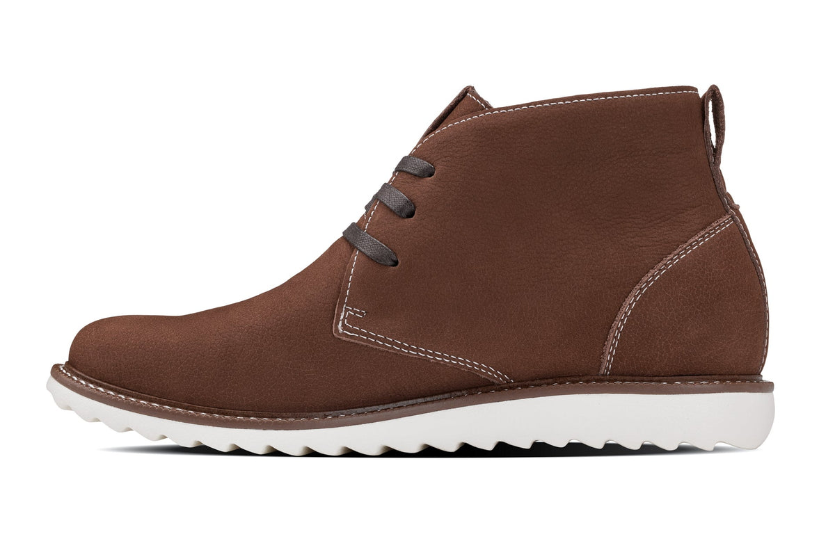 Brown lace-up chukka boots with contrast stitching and white rubber outsole