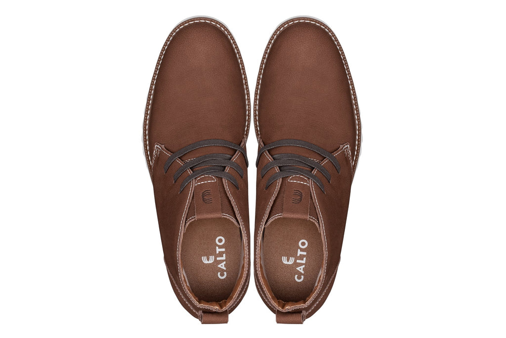 Brown nubuck chukka boots, lace-up front and stitched upper, with white outsole