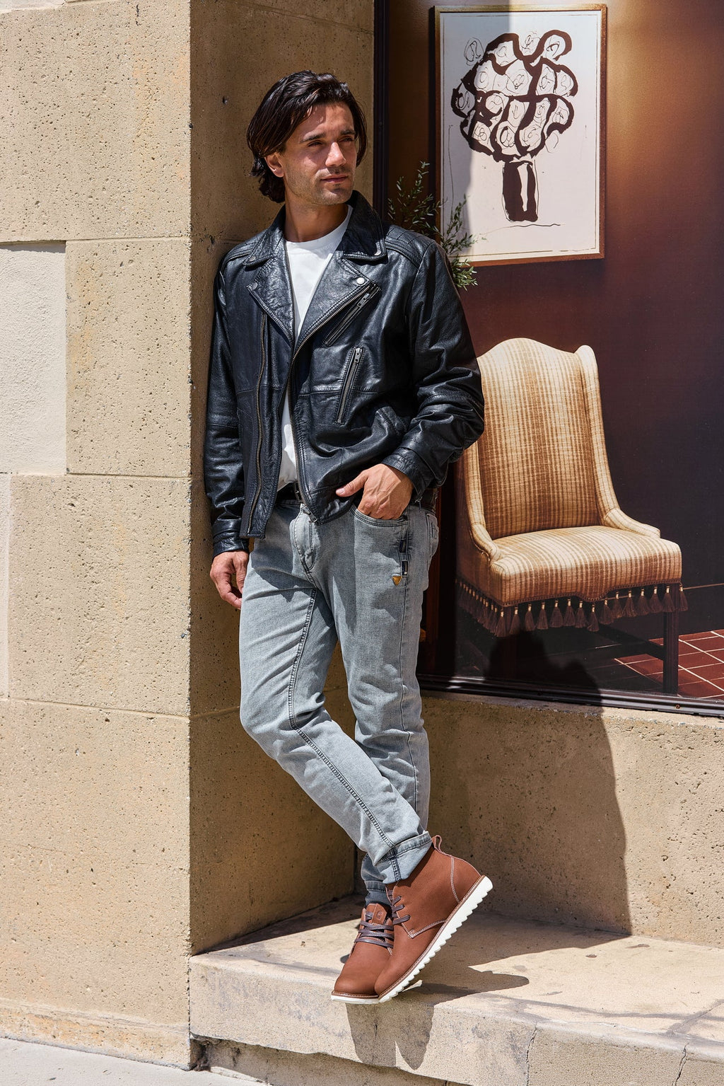 Brown nubuck chukka boots worn with jeans; lace-up front and white rubber outsole