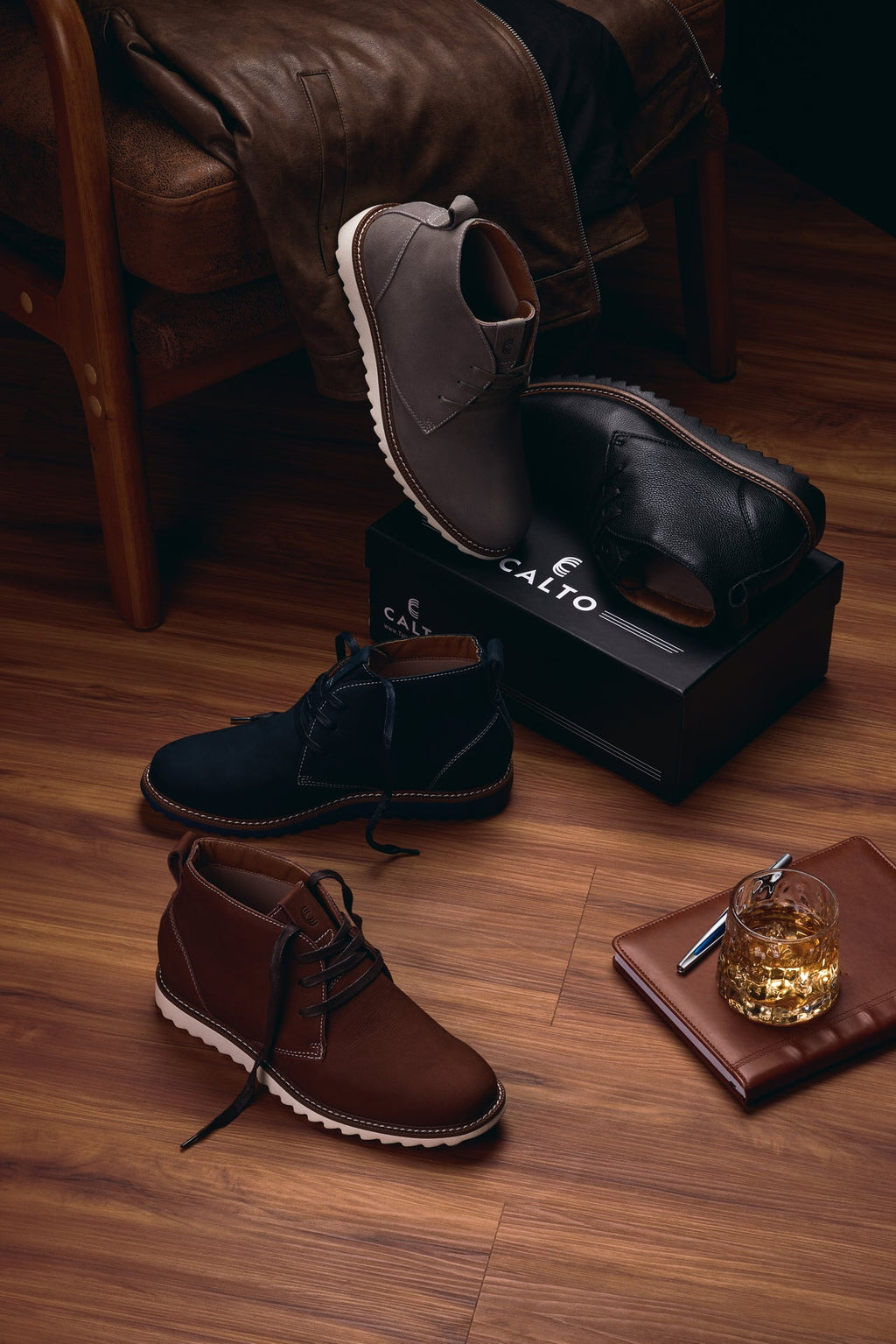 Navy chukka boots with CALTO logo on insole, shown with lace-up detail