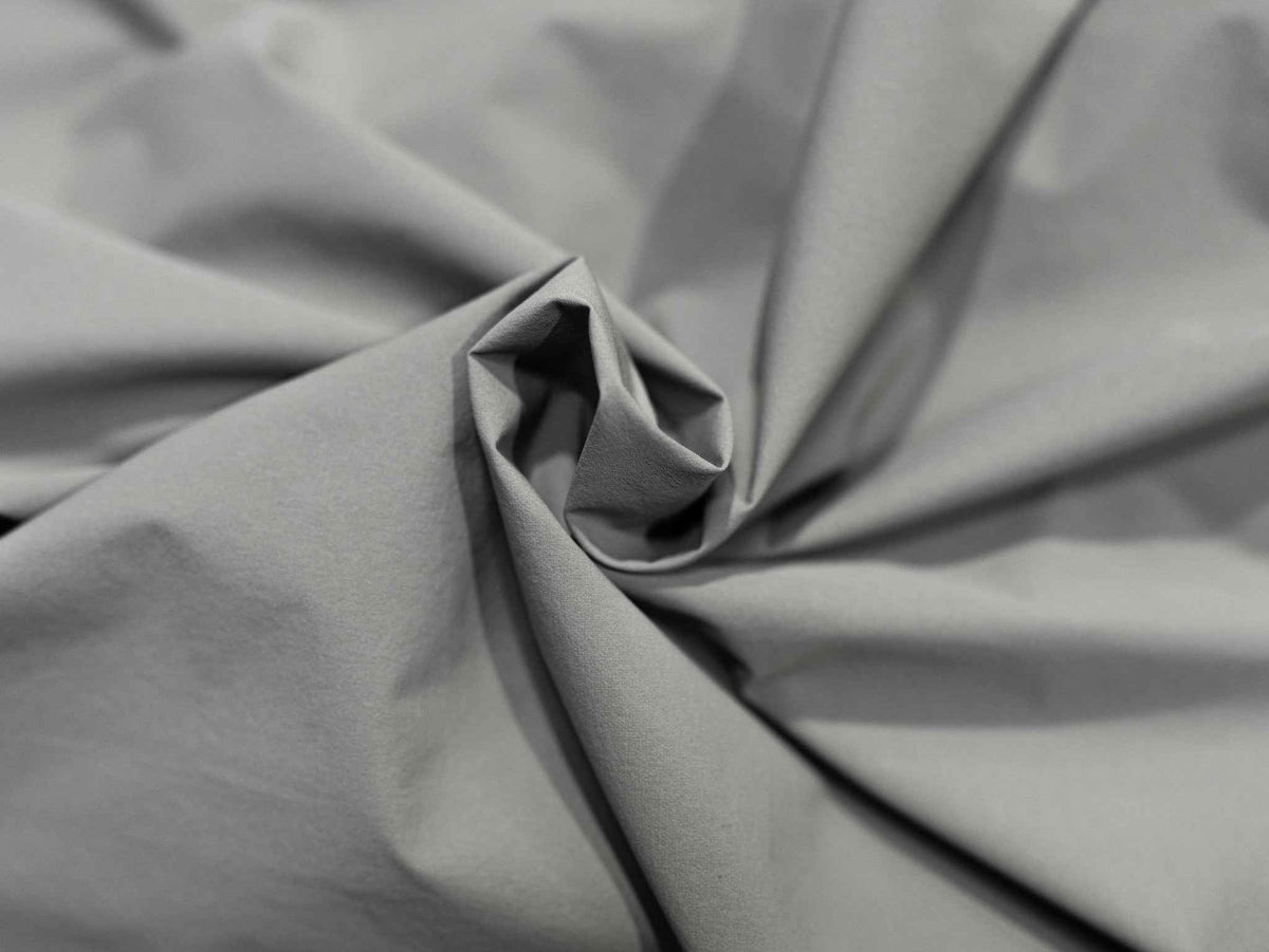 Dark gray jacket fabric close-up with subtle ripstop texture