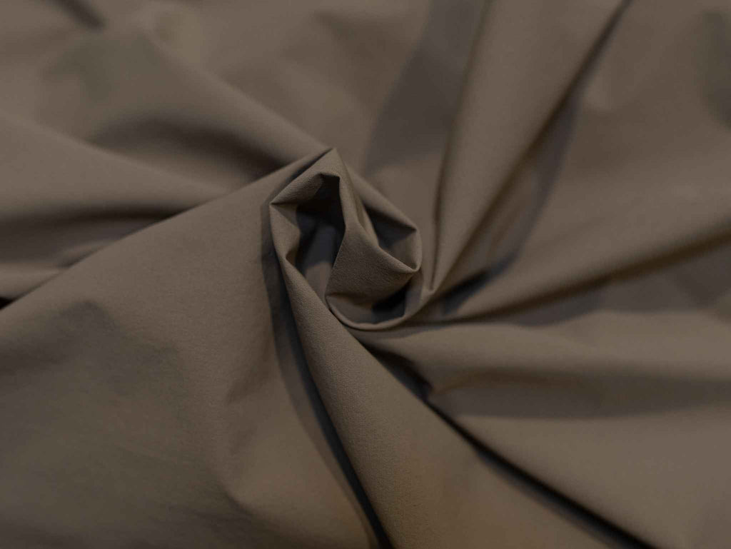 Men's journey jacket fabric close-up, matte olive-brown weave