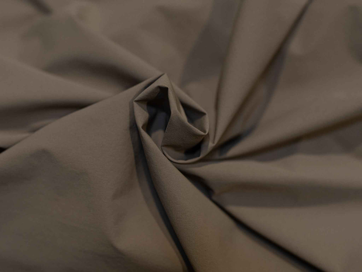 Men's journey jacket fabric close-up, matte olive-brown weave
