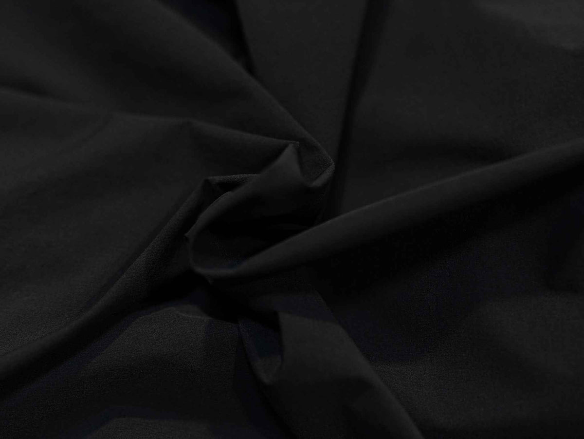 Men's jacket fabric close-up in dark solid weave