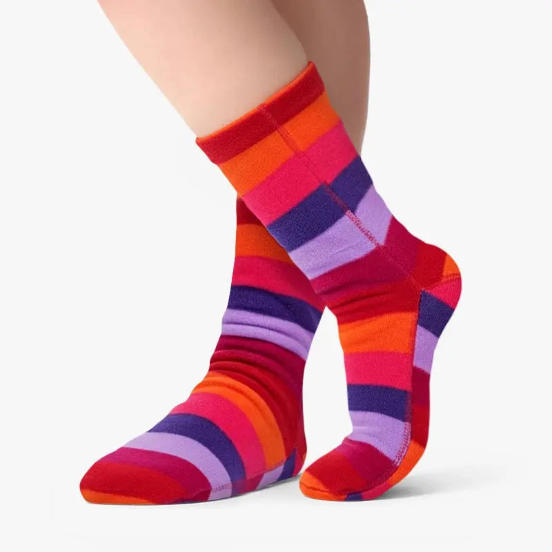 Pair of multicolor striped fleece socks on legs, with purple toe accents