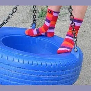 Striped fleece socks with orange and purple tones, feet dangling near slide