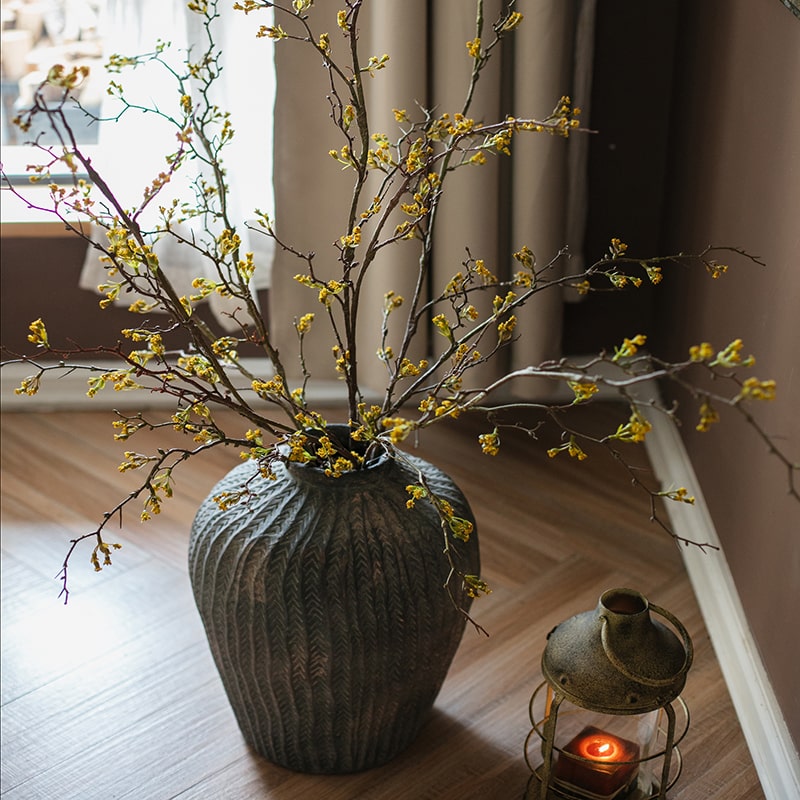 Tall artificial branching flower stem with tiny yellow blossoms and buds