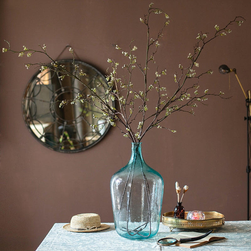 Tall artificial branching flower stem with small yellow blossoms