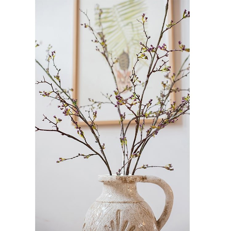 Tall artificial branching flower stem with tiny purple blossoms and buds