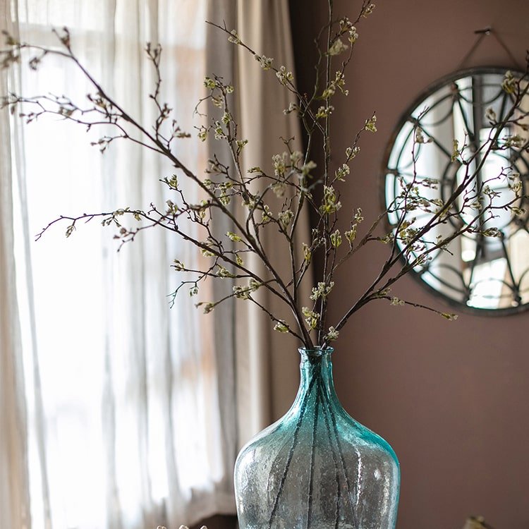 Tall artificial branching flower stem with small yellow buds