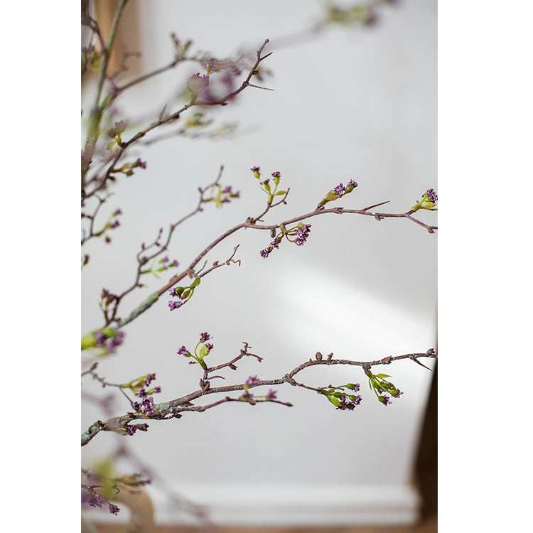 Tall artificial branching flower stem with small purple flowers and buds