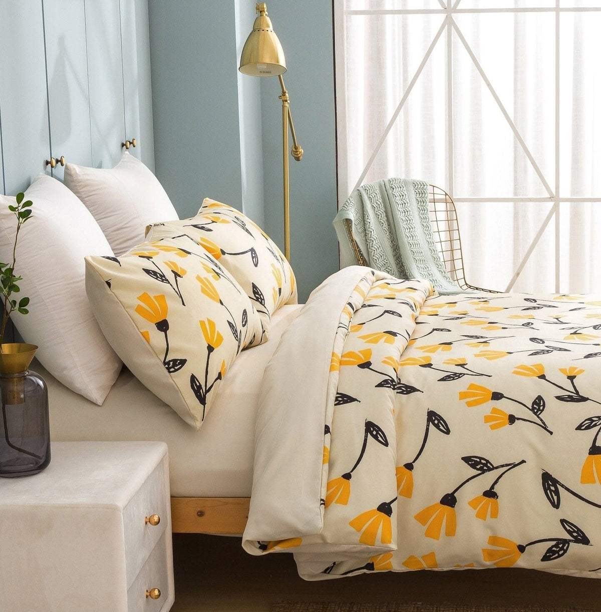 Yellow tulip floral duvet cover set on a sofa with coordinating pillow shams