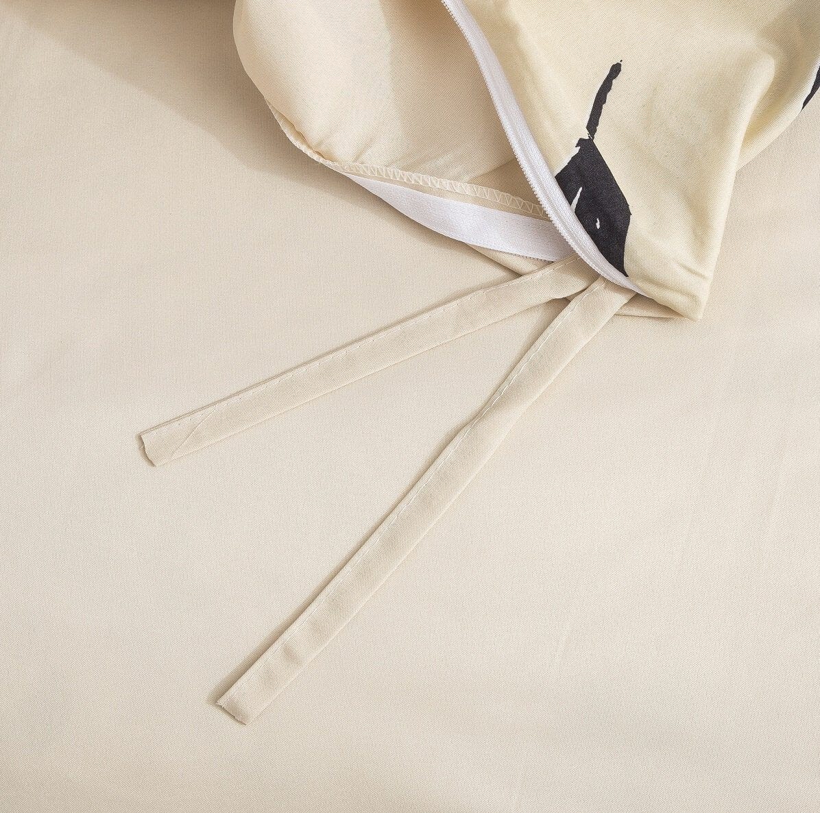 Cream duvet cover corner with fabric tie straps and zipper edge detail