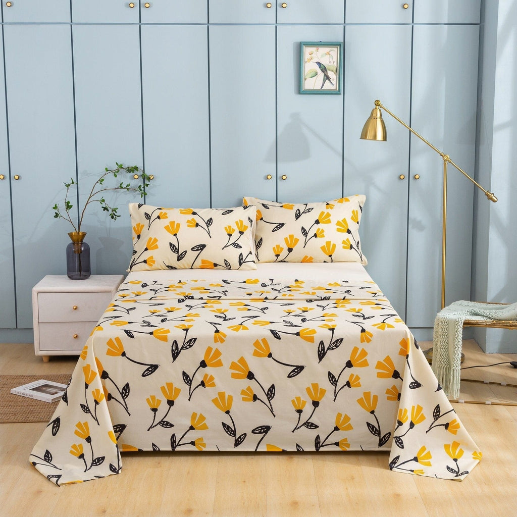 Ivory bedspread with yellow floral and leaf print, matching pillow shams on neatly made bed