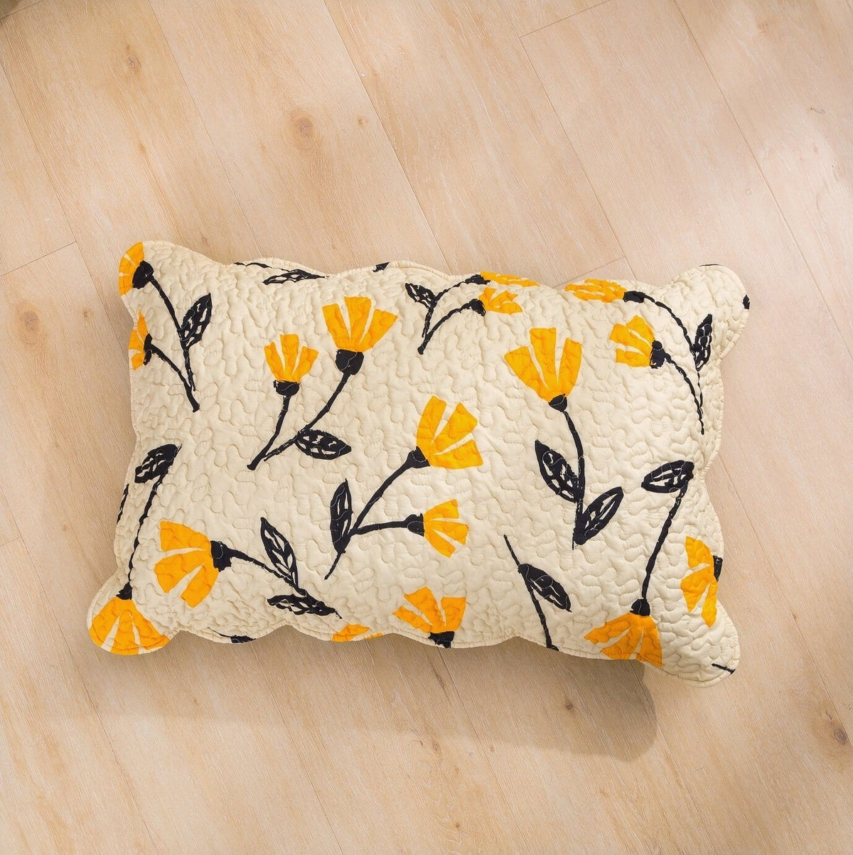 Quilted ivory accent pillow with yellow fleur floral print and black stems, rectangular