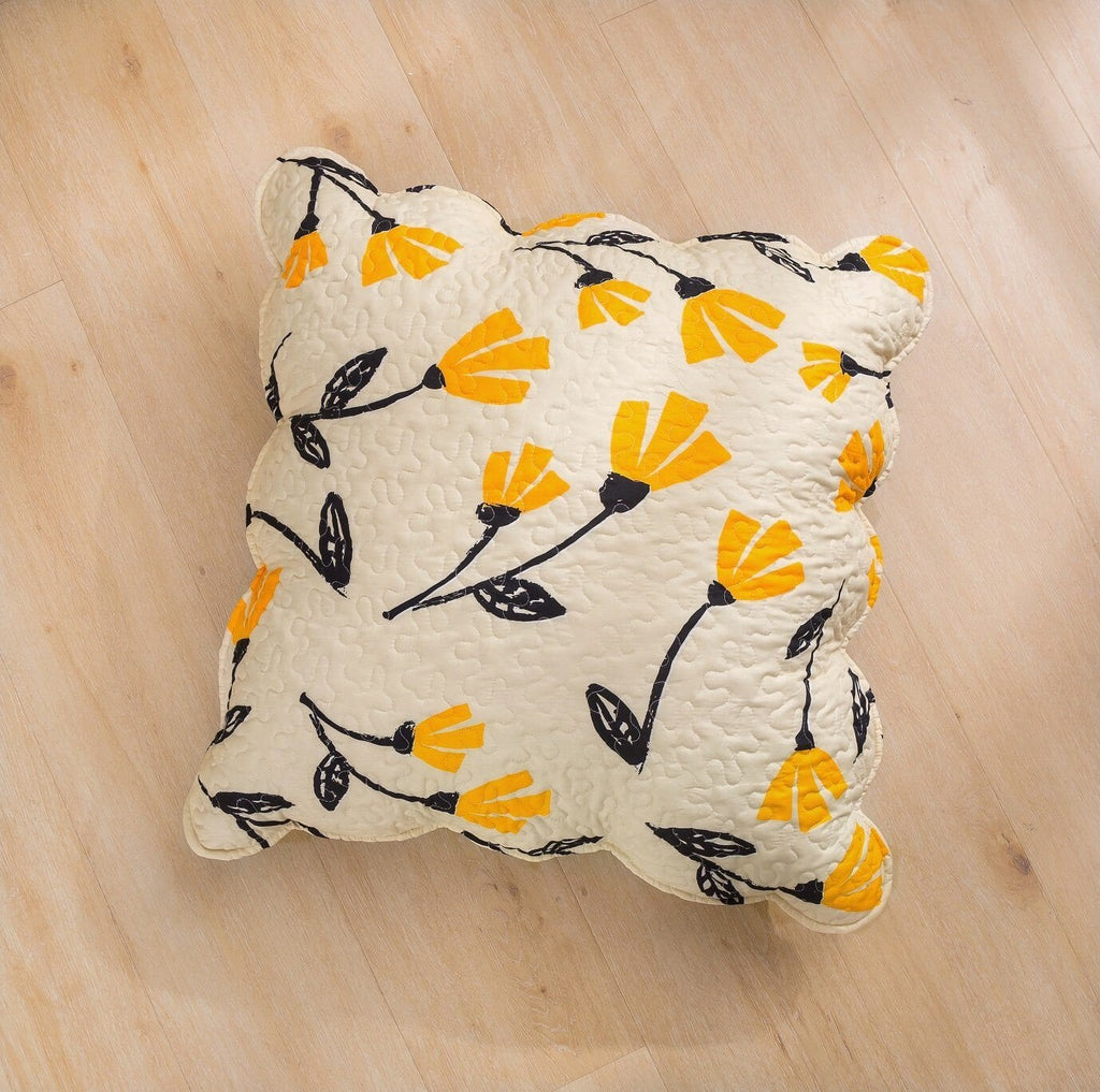 Quilted ivory accent pillow with yellow flower sprig print and black botanical outlines