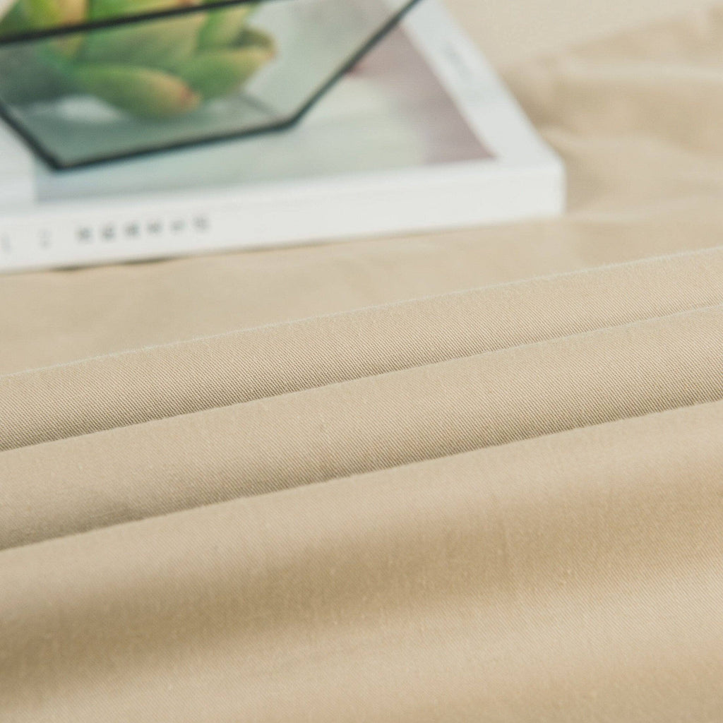 Solid light tan fitted sheet with smooth woven texture