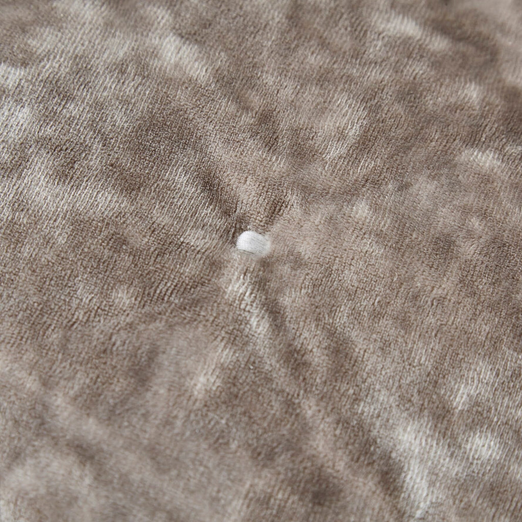 Taupe plush velvet fabric with small tufted bumps and textured weave, close-up