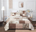 Patchwork quilted bedspread with floral blocks in dusty rose, taupe, and beige