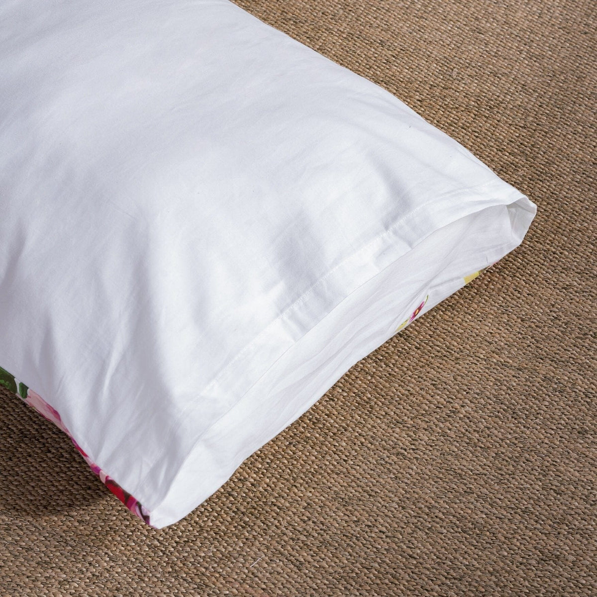 White pillowcase corner with pink rose floral trim