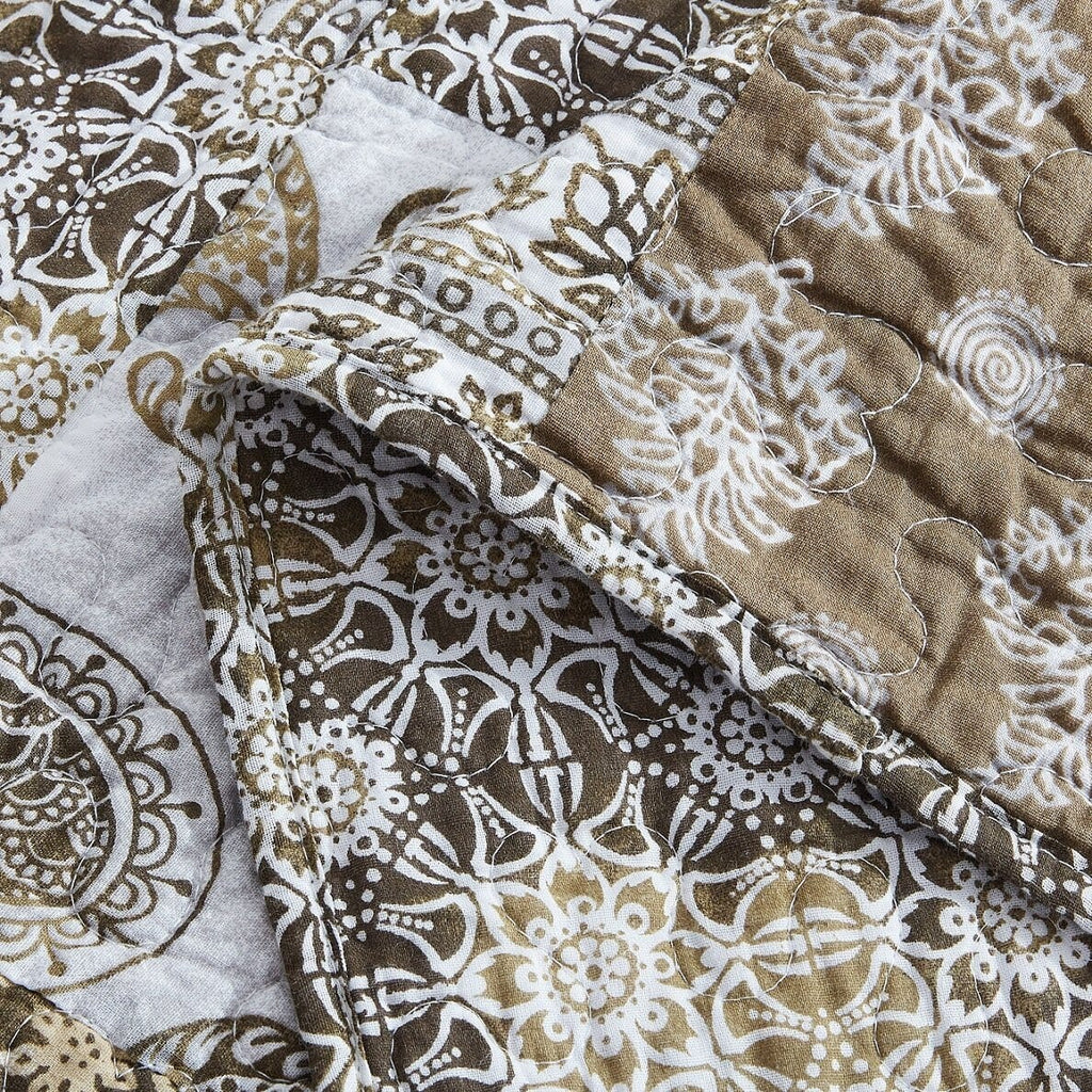 Olive-brown and white comforter with paisley floral patchwork and quilted stitching