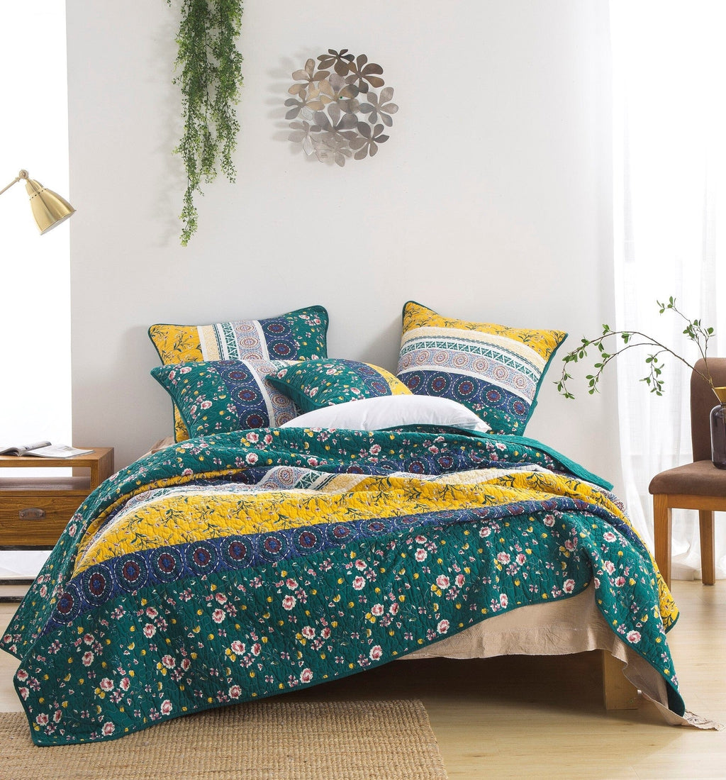 Patchwork quilt set with teal floral and yellow accents, decorative pieced pattern