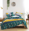 Patchwork quilt set with teal floral and yellow accents, decorative pieced pattern