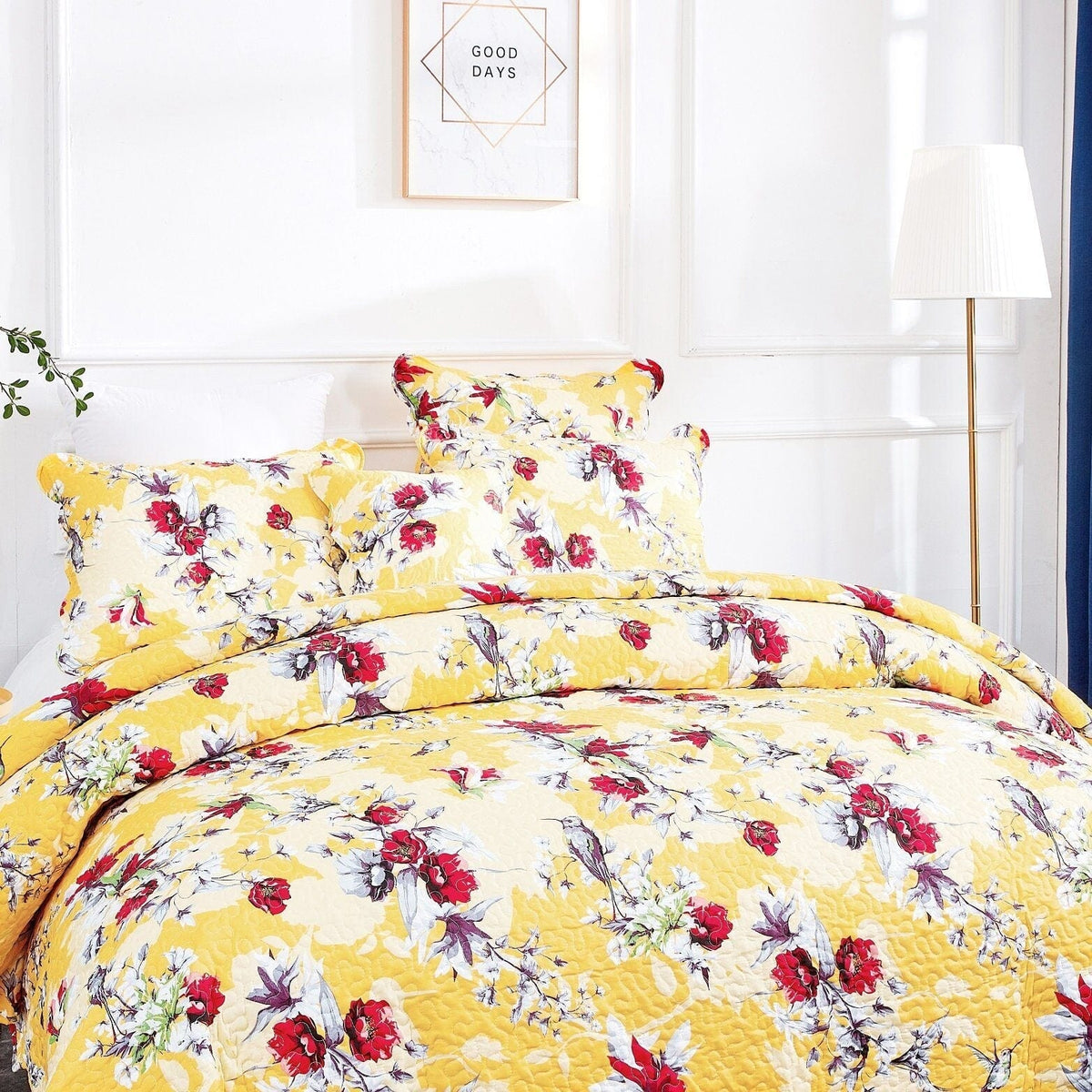 Sunshine yellow quilt top with hummingbird floral pattern and matching pillow shams