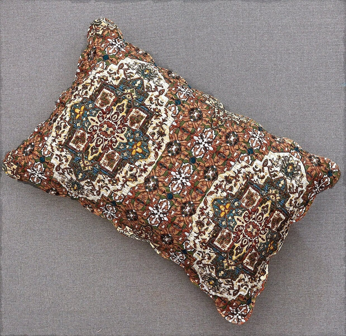 Quilted decorative pillow sham with ornate folk medallion pattern and textured edge