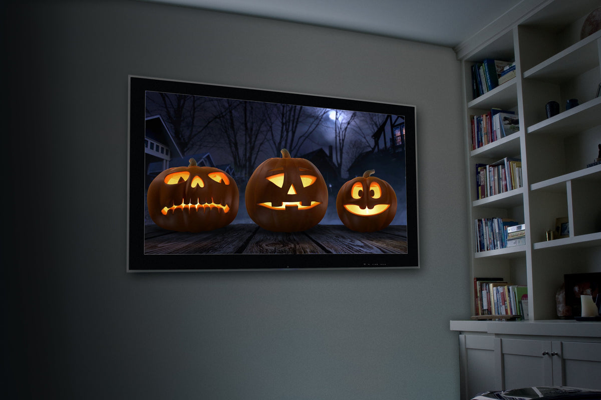 Jack-o-lantern pumpkin projection image on a framed wall screen