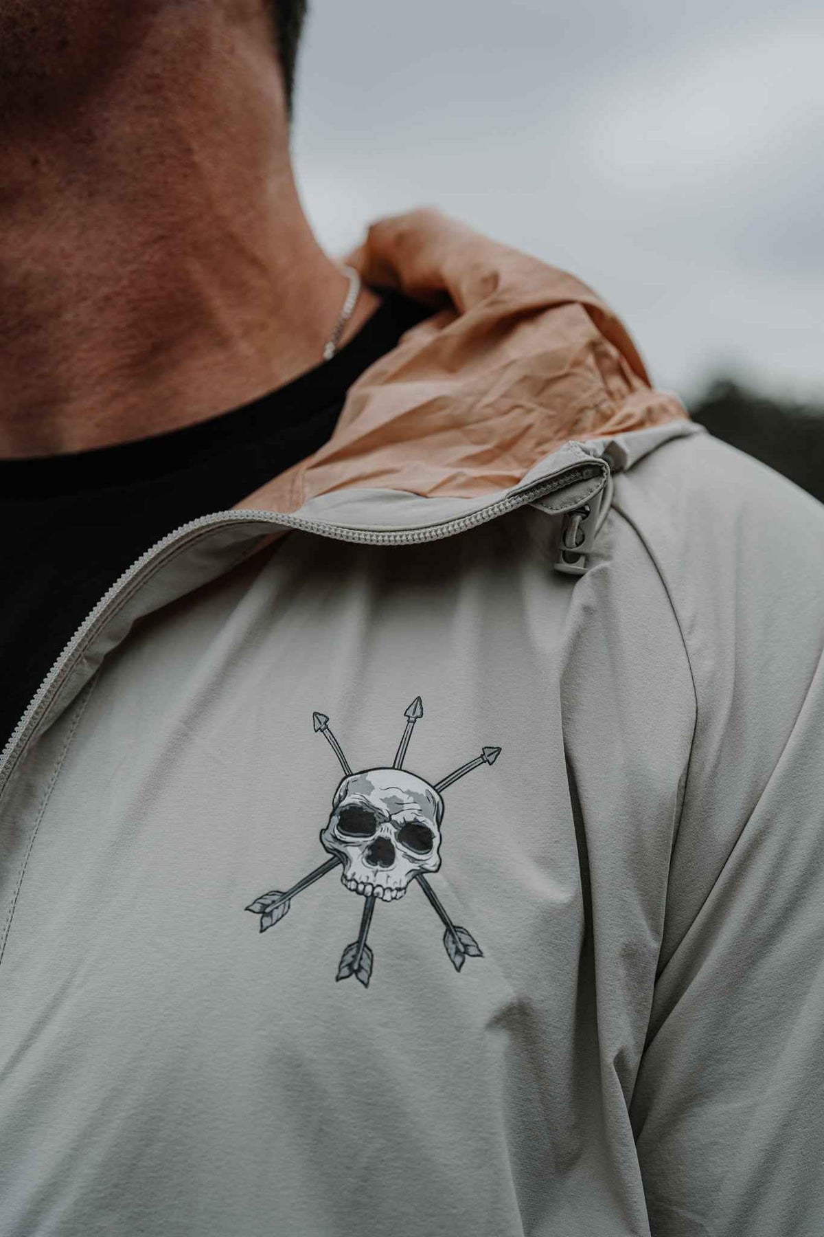Men's Journey Jacket light gray; hood collar and skull-like chest graphic detail