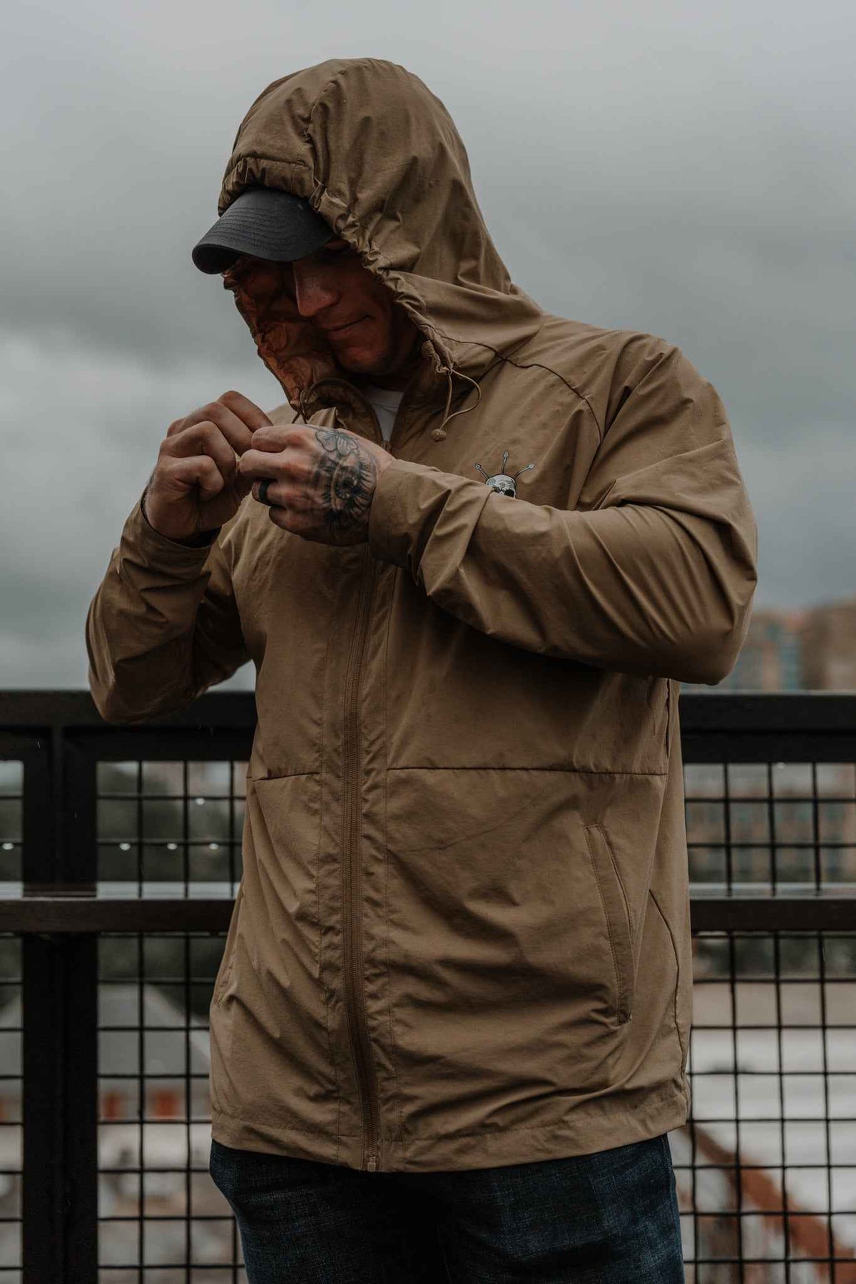 Men's olive Journey jacket close-up with hood and chest zipper detail
