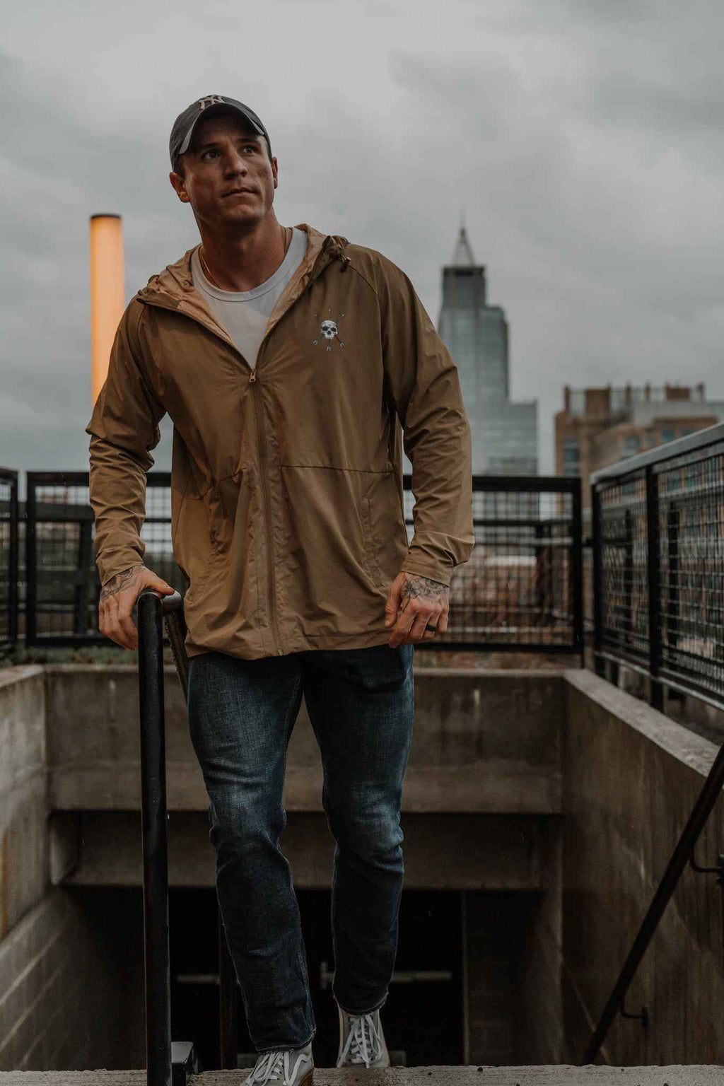 Men's olive Journey jacket worn front view with hood and zipper