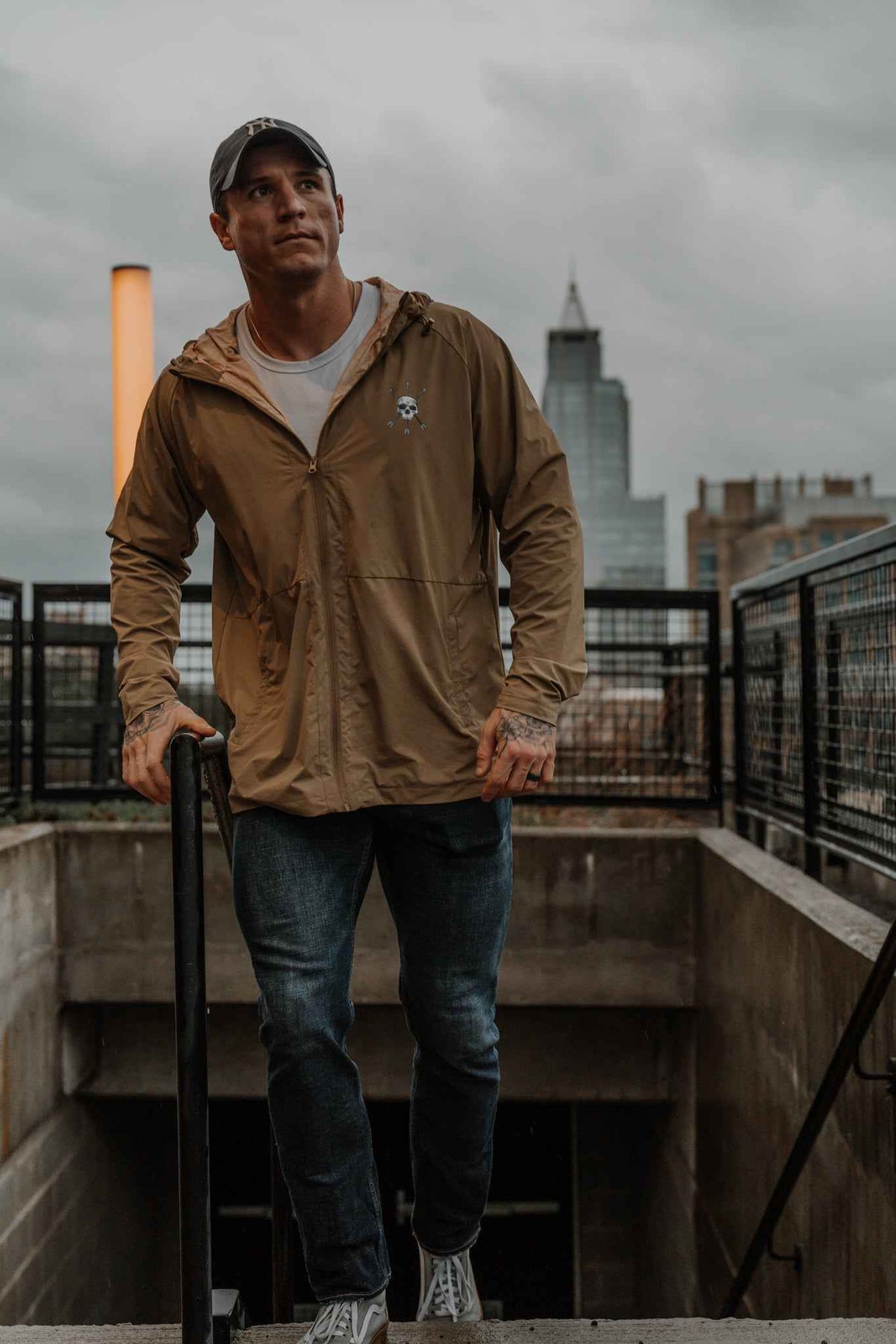 Men's olive Journey jacket worn front view with hood and zipper
