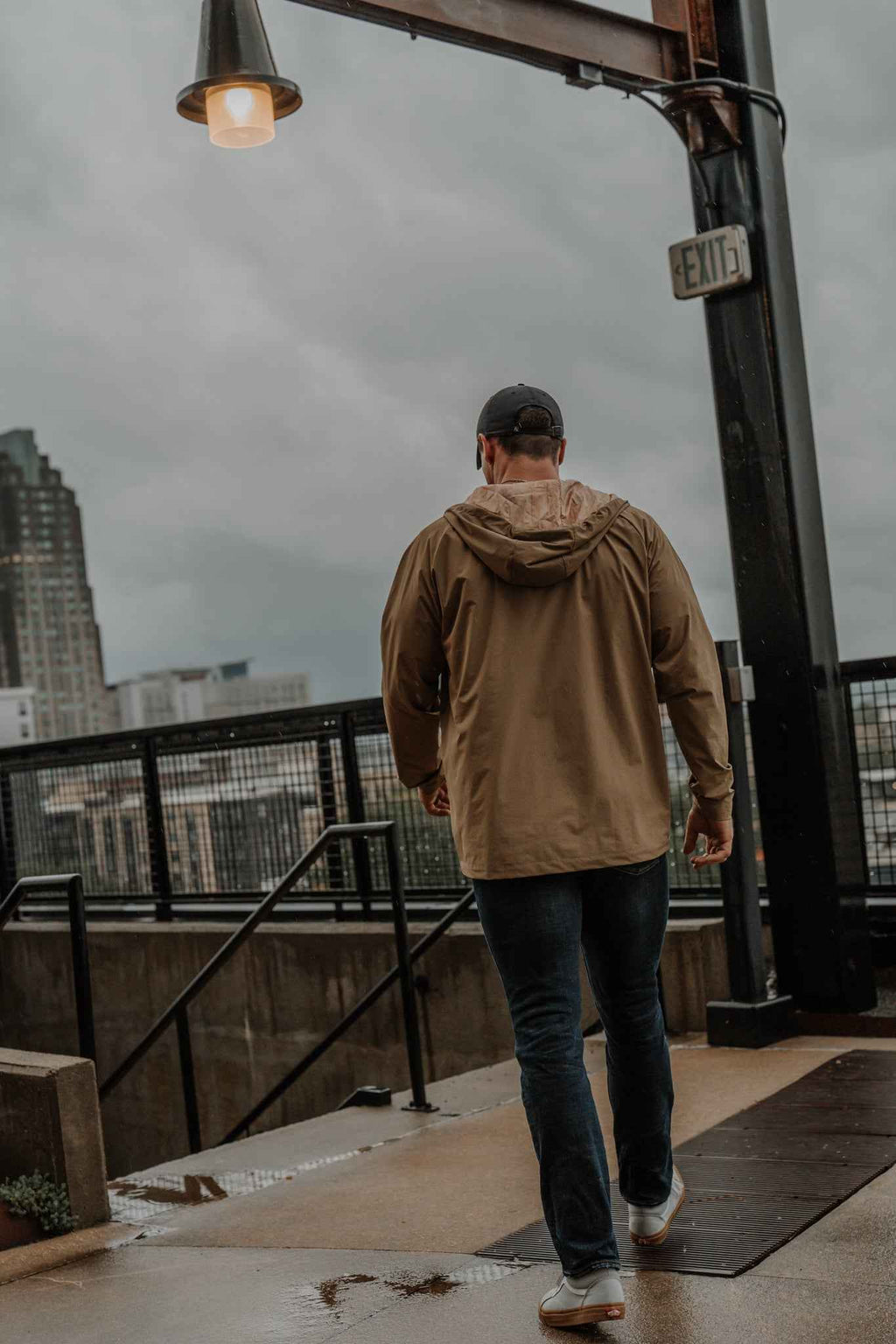 Men's olive Journey jacket from back with hood and zip-up silhouette
